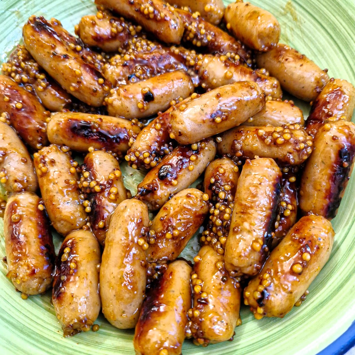 Close up of sticky cocktail sausages.