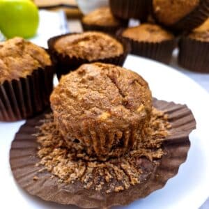 Close up of a bran flake honey muffin on an opened paper liner.
