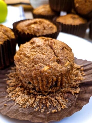 Close up of a bran flake honey muffin on an opened paper liner.