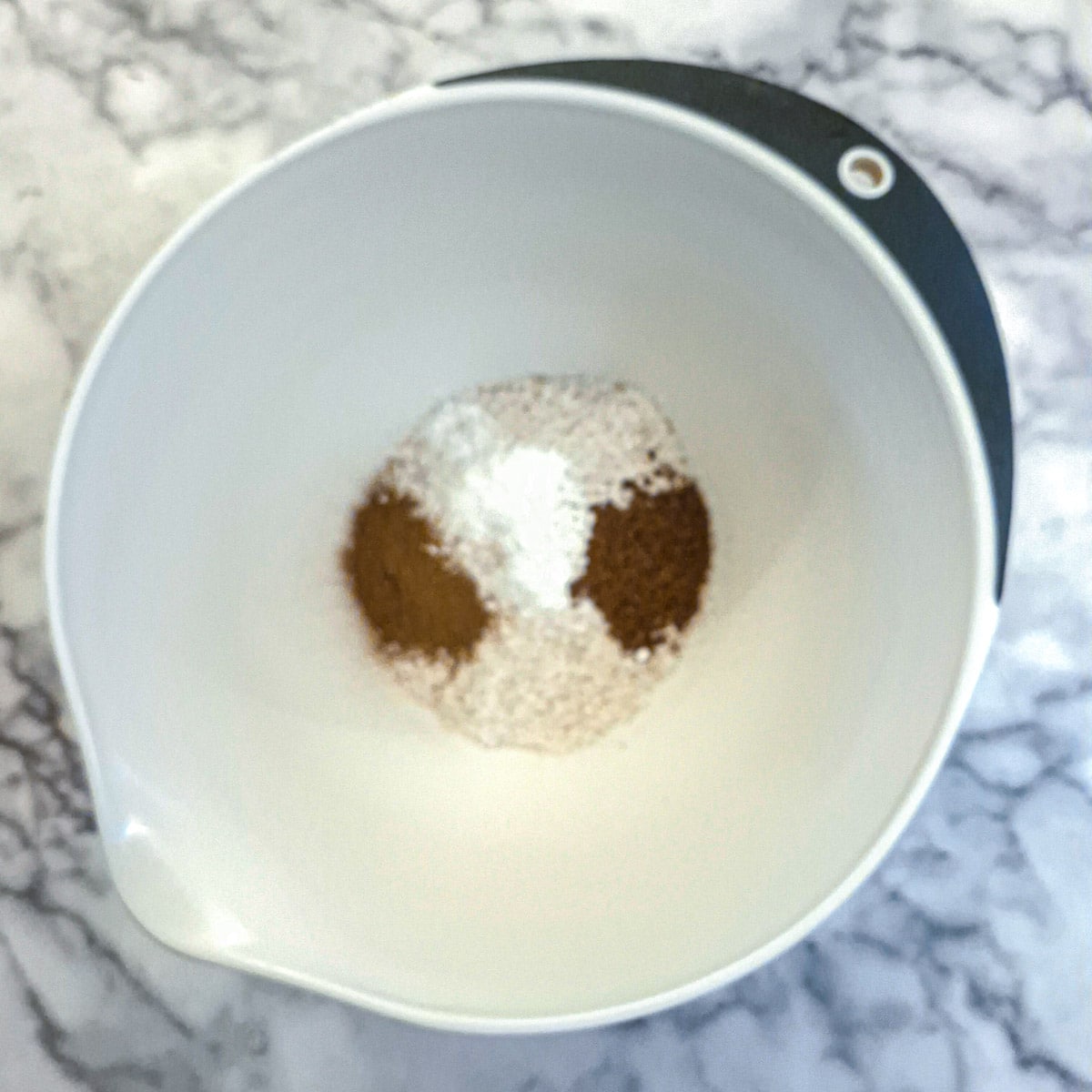 Dry ingredients for honey bran muffins in a mixing bowl.