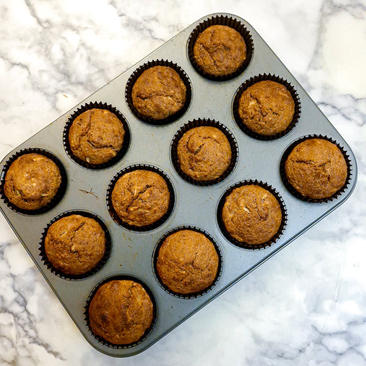12 baked muffins in a tray.