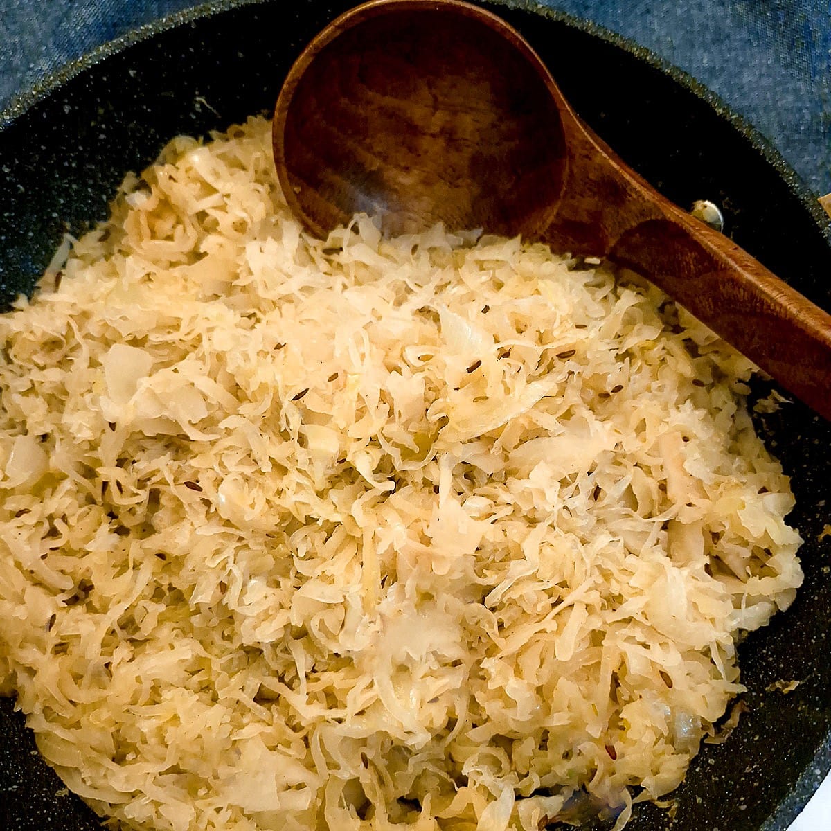 Close up of the prepared sauerkraut n a blue dish.