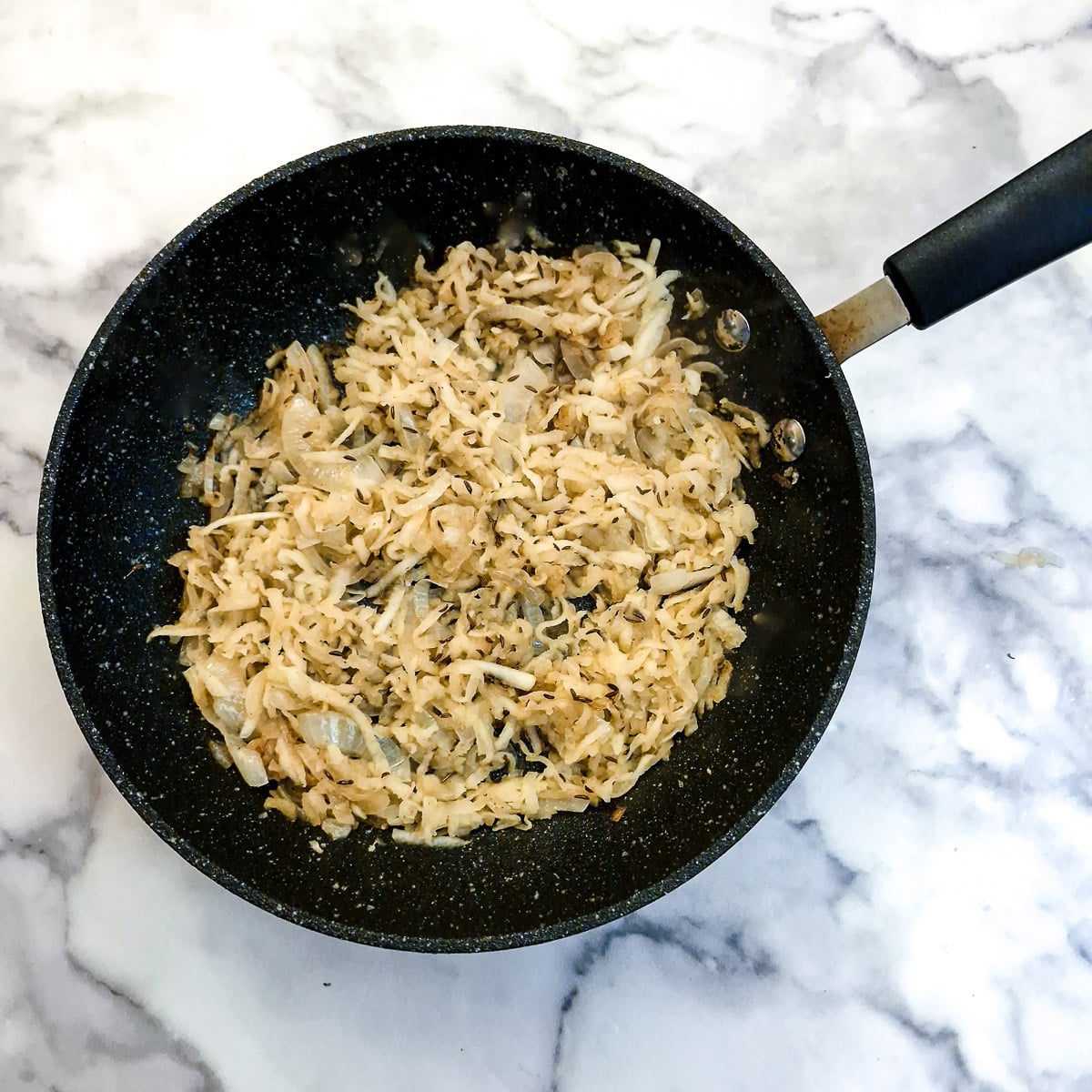Grated apple and caraway seeds added to the onions.