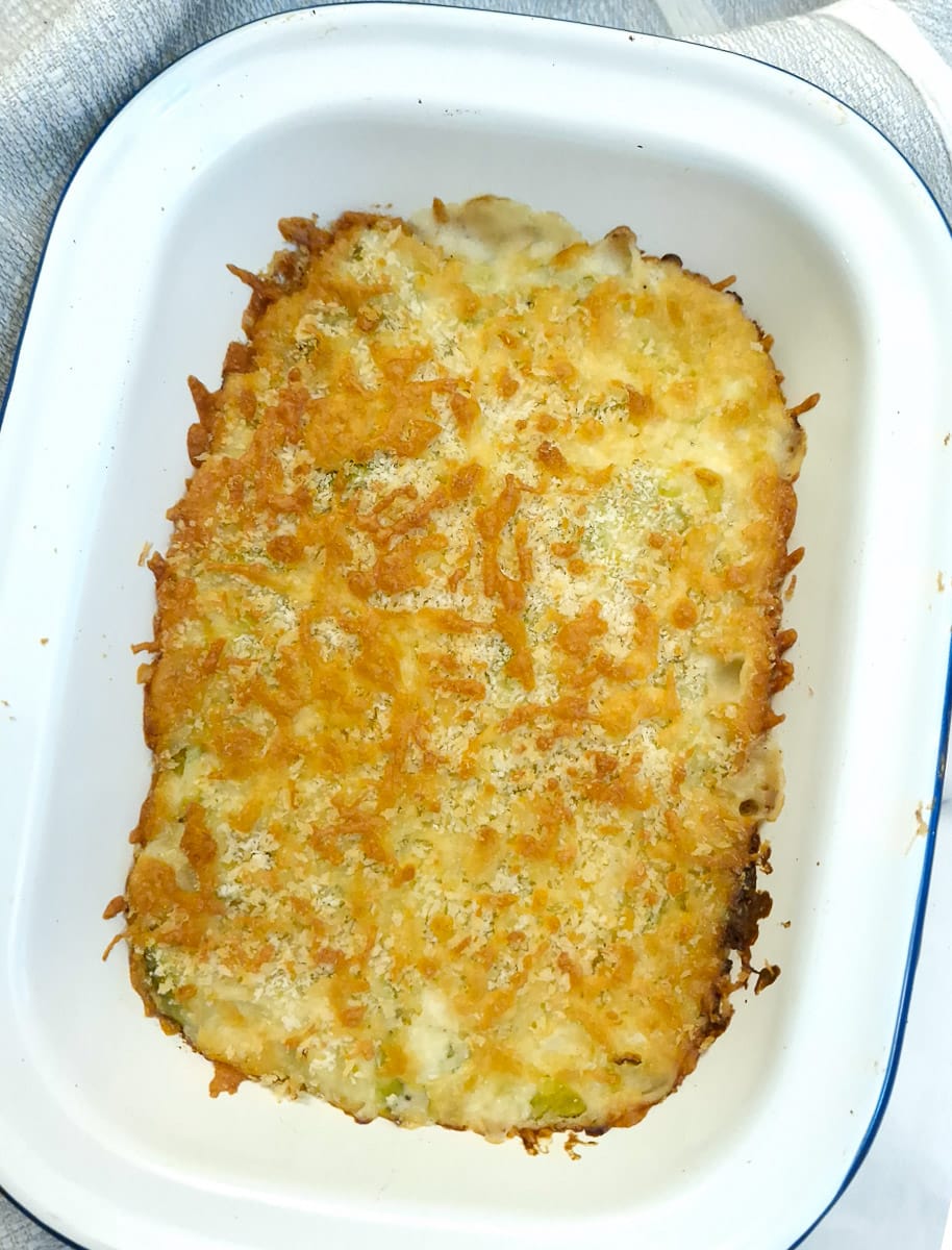 Overhead shot of leek and brussels sprouts bake covered with melted cheese.