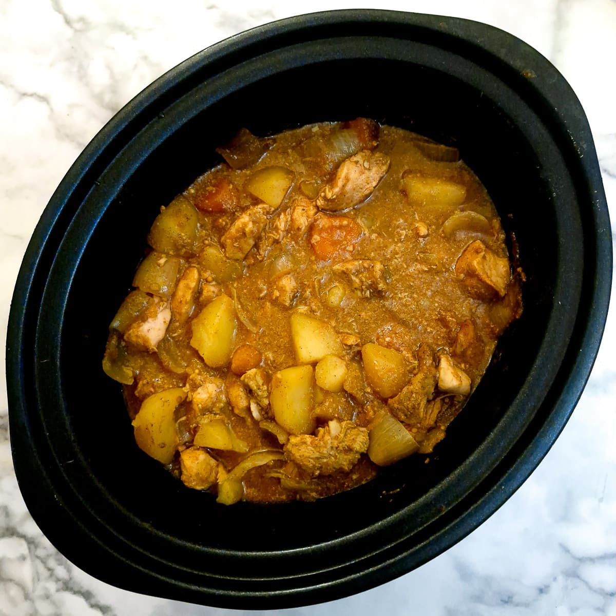 Cooked chicken curry in a slow cooker.