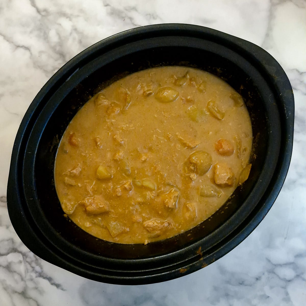 Blended vegetables and gravy stirred back into the curry to thicken it.