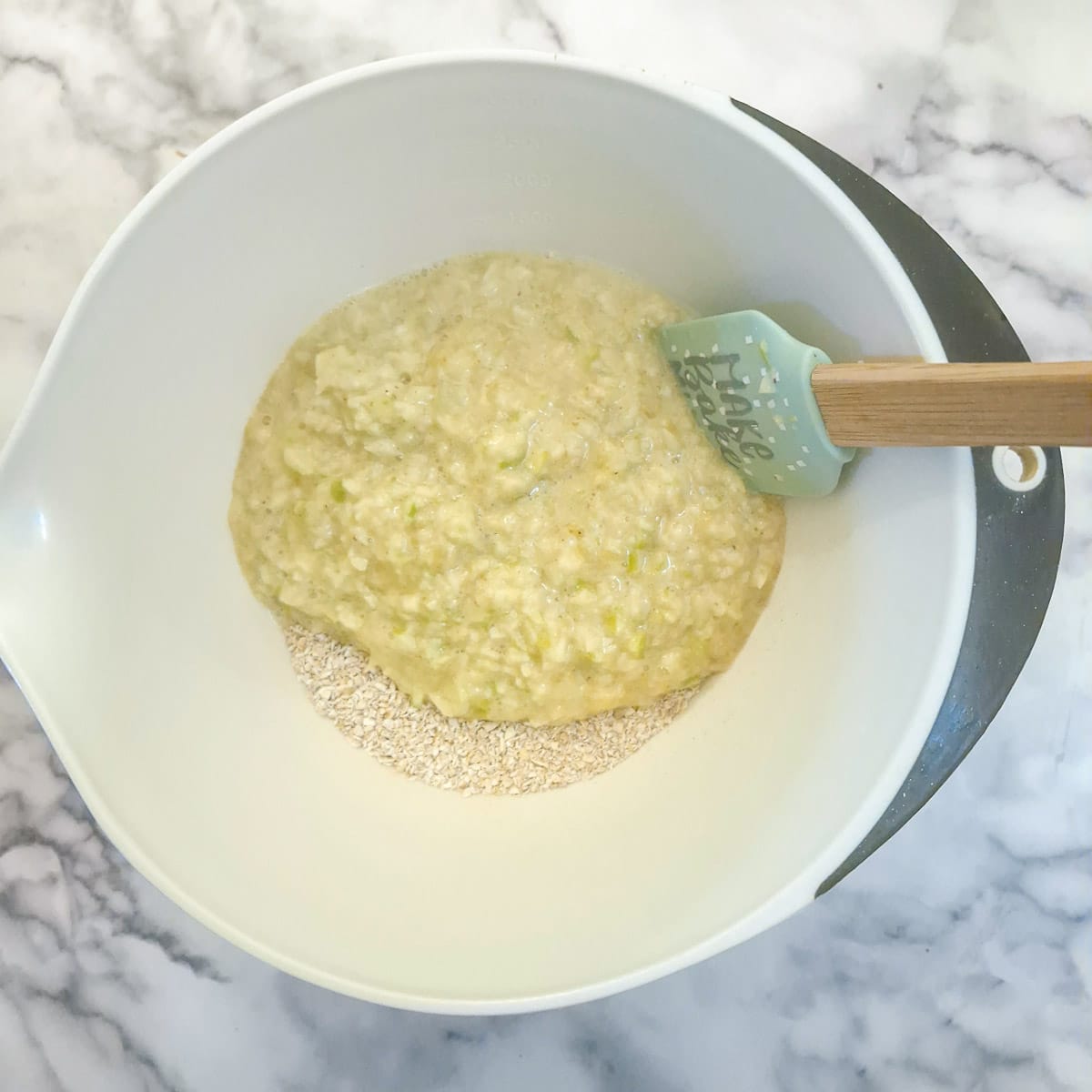 The wet ingredients being added to the dry ingredients.