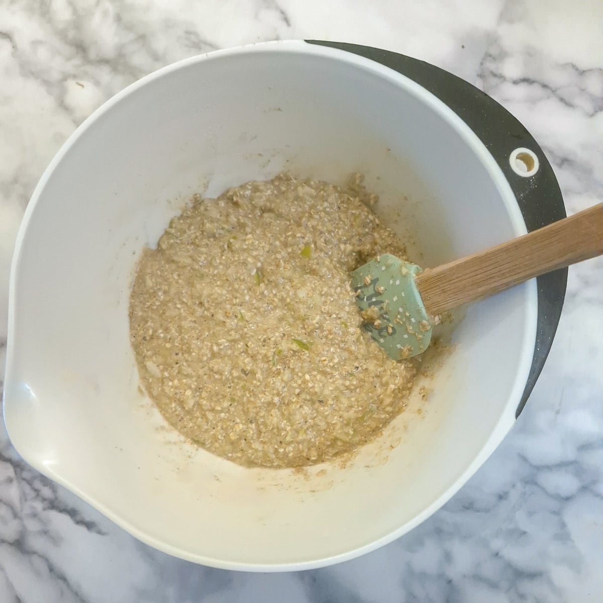 Mixed honey oat banana loaf batter in a mixing bowl.
