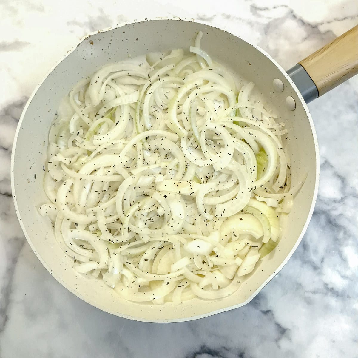 Sliced onions in a frying pan.