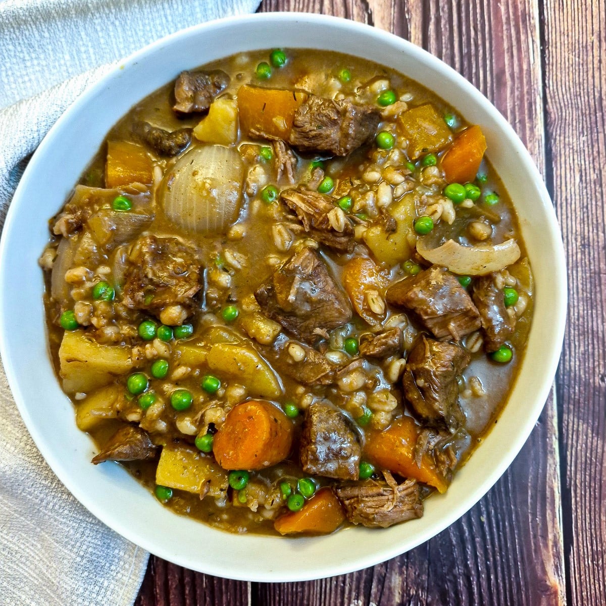 Overhead shot of beef and vegetable stew in a serving bowl.