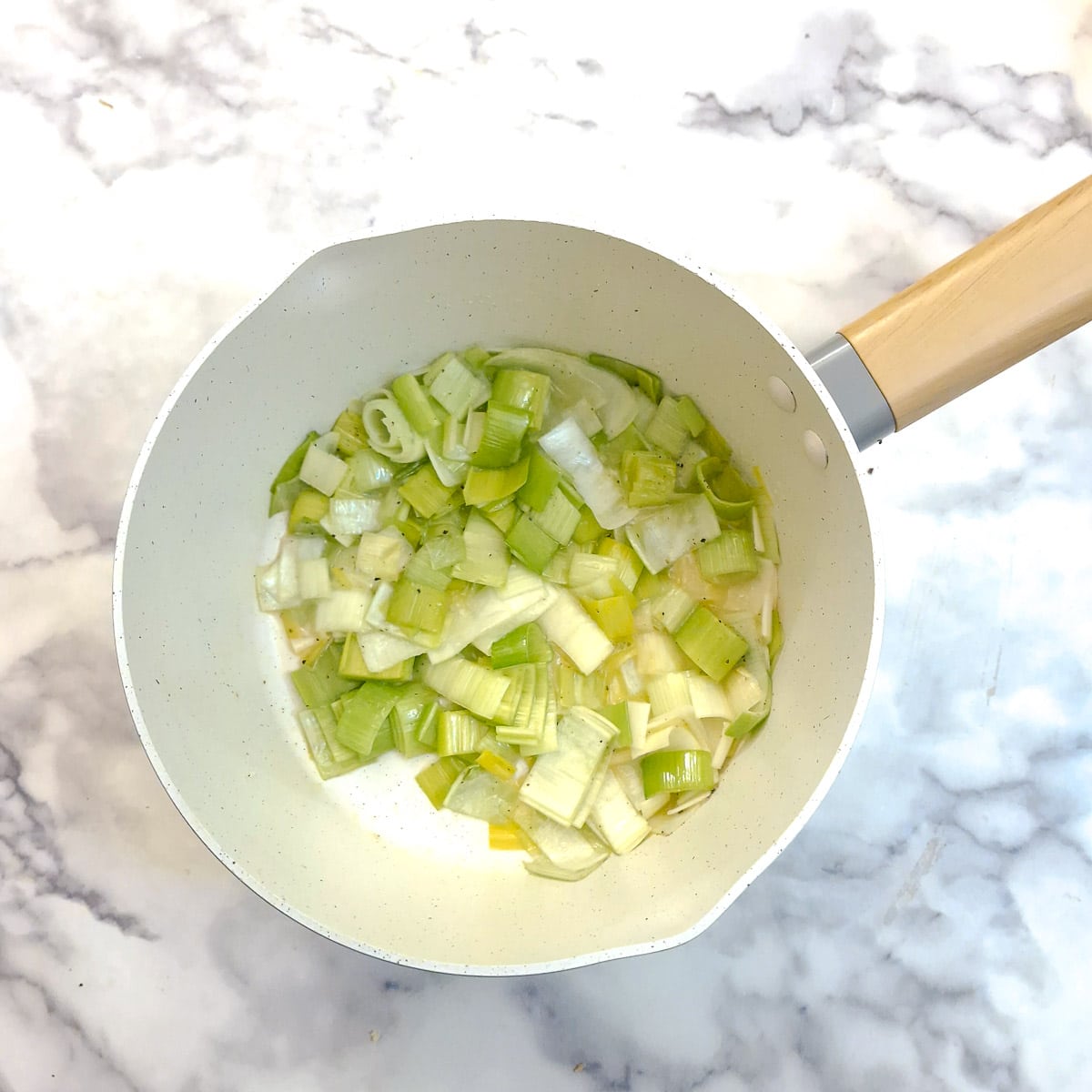 Chopped leeks softening in butter.