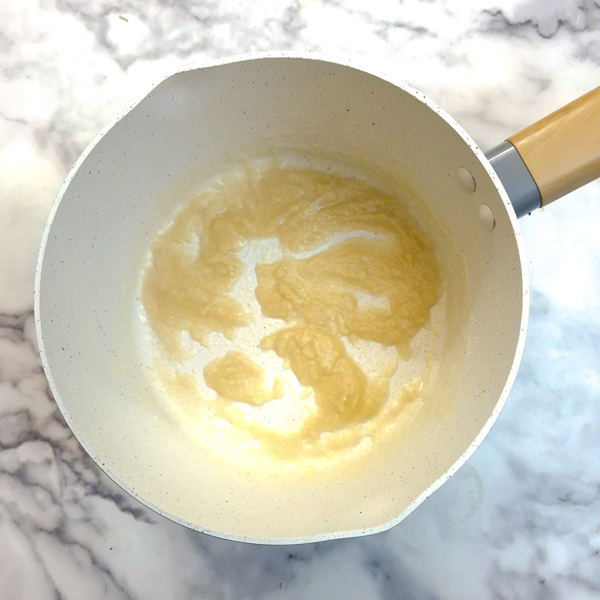 Melted butter combined with flour to make a roux in a saucepan.