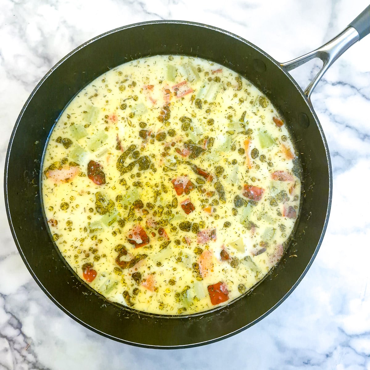 Milk and chopped dill added to vegetables.