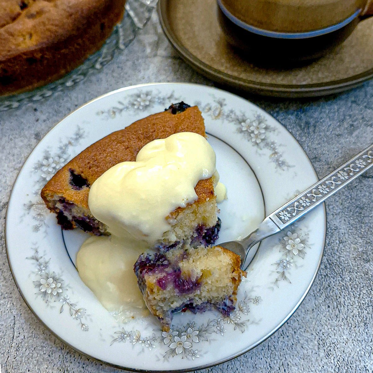 Vanilla custard poured over a slice of cake.