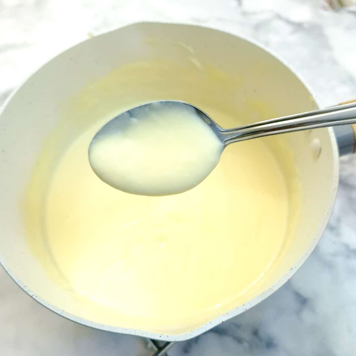 A saucepan of vanilla custard.
