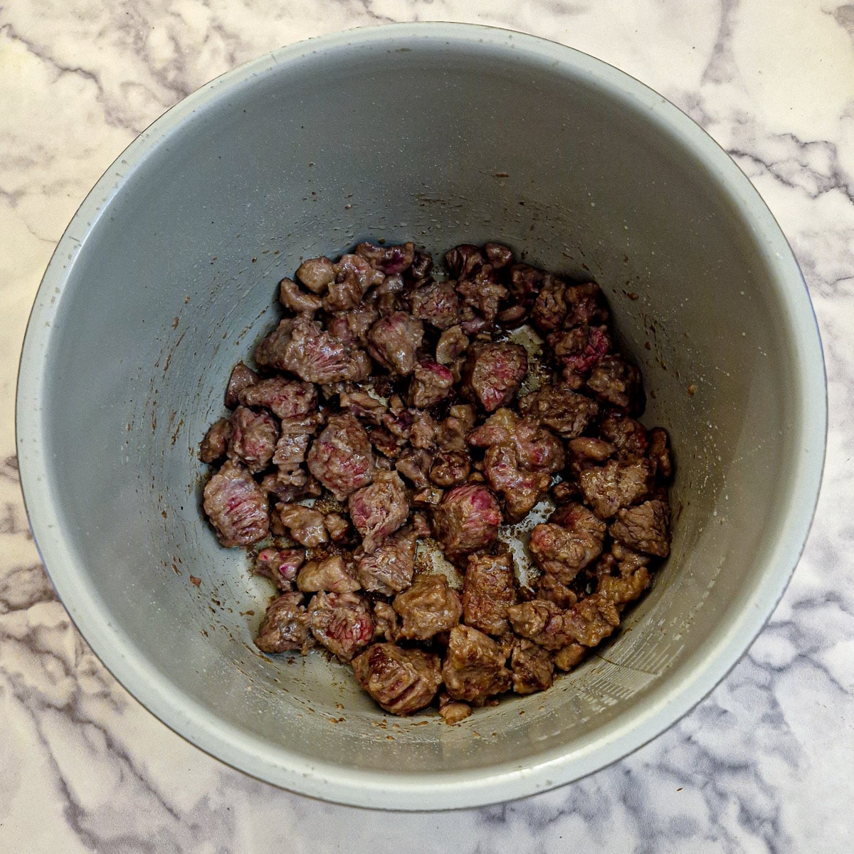 Steak and kidney browning in a pressure cooker.