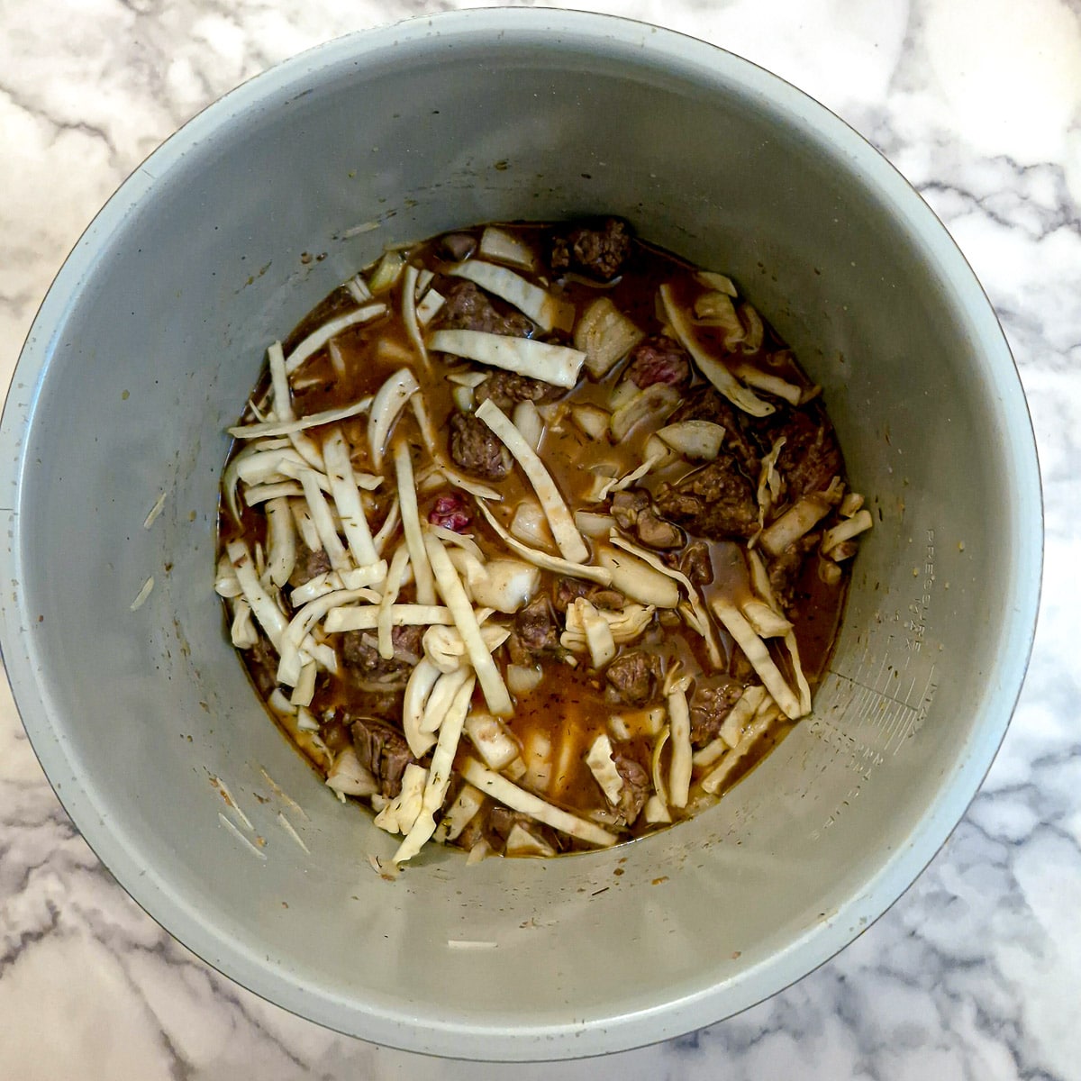 Cabbage and stock added to the hotpot.