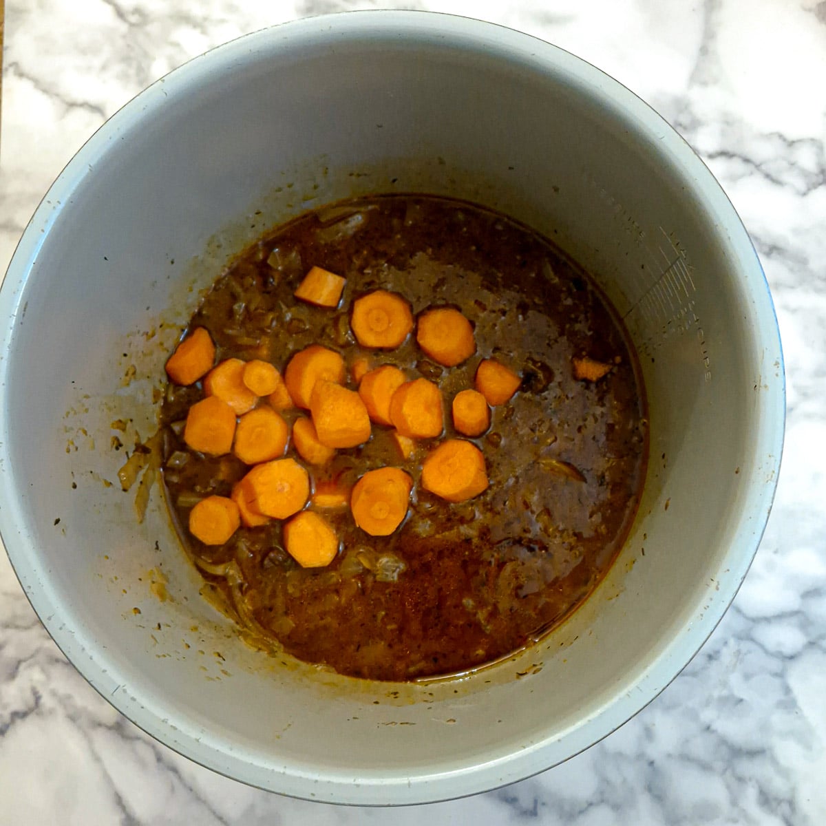 Carrots added to the pressure cooker.