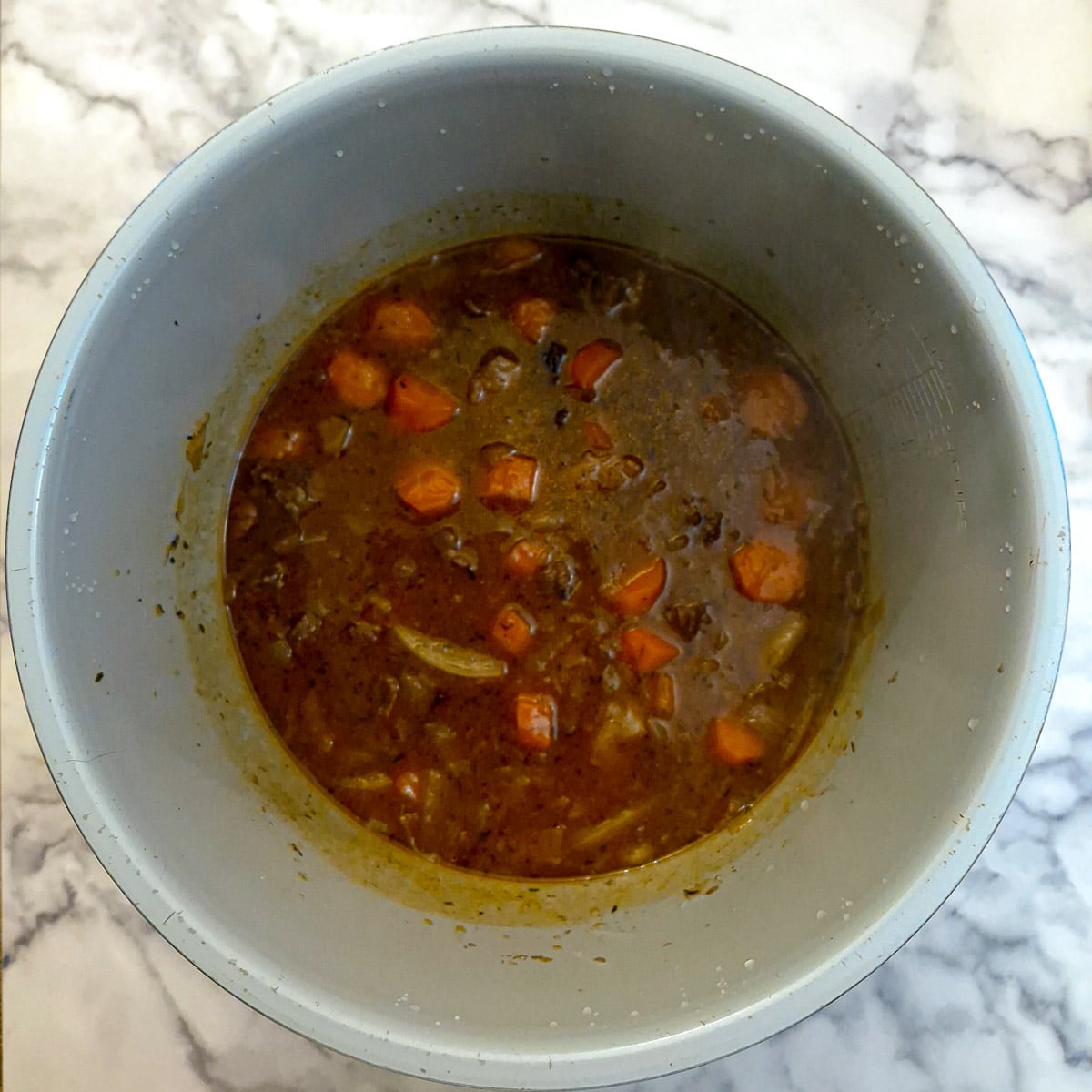 The fully cooked steak and kidney filling in a pressure cooker.