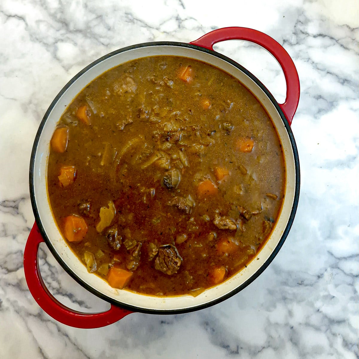 Steak and kidney in gravy transferred to a casserole dish.