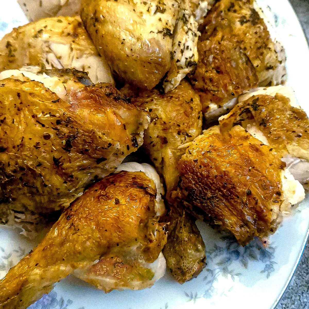Carved pieces of air fryer chicken on a plate.