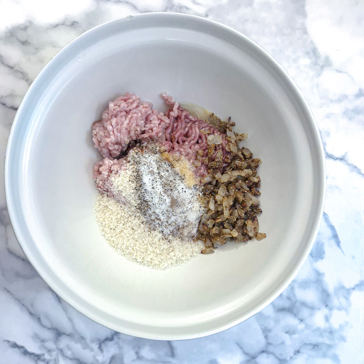 Boerewors sausage ingredients in a mixing bowl.