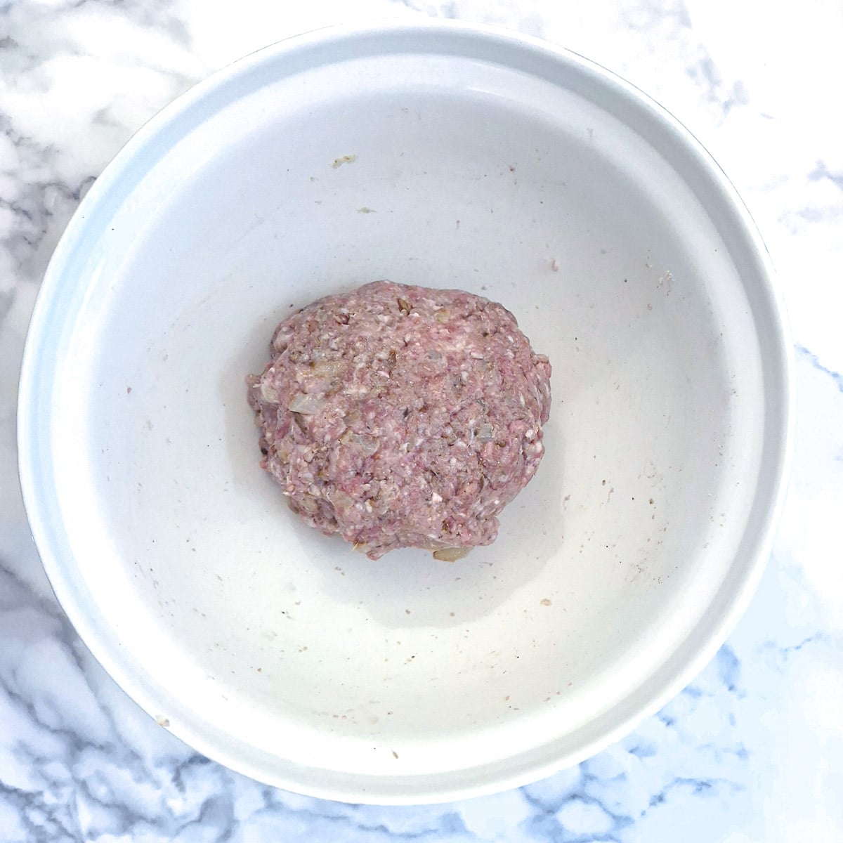 A ball of boerewors meat mixture in a mixing bowl.