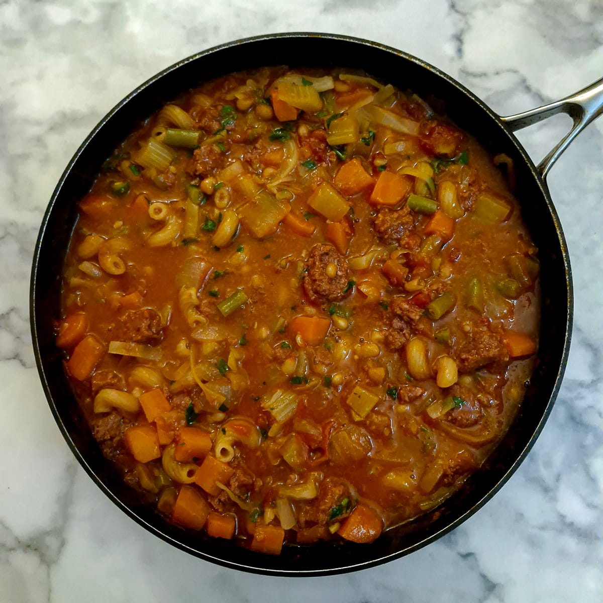 A saute pan fille with cooked bully beef minestrone.