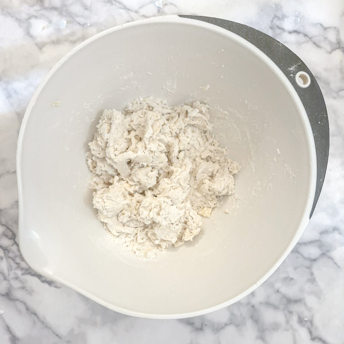 A bowl of shaggy dough.