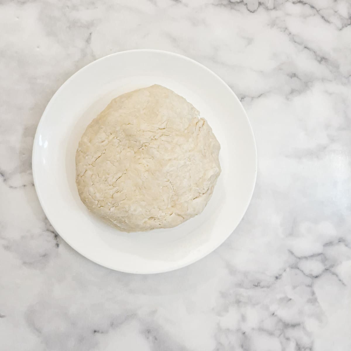 A ball of flaky pastry on a plate.