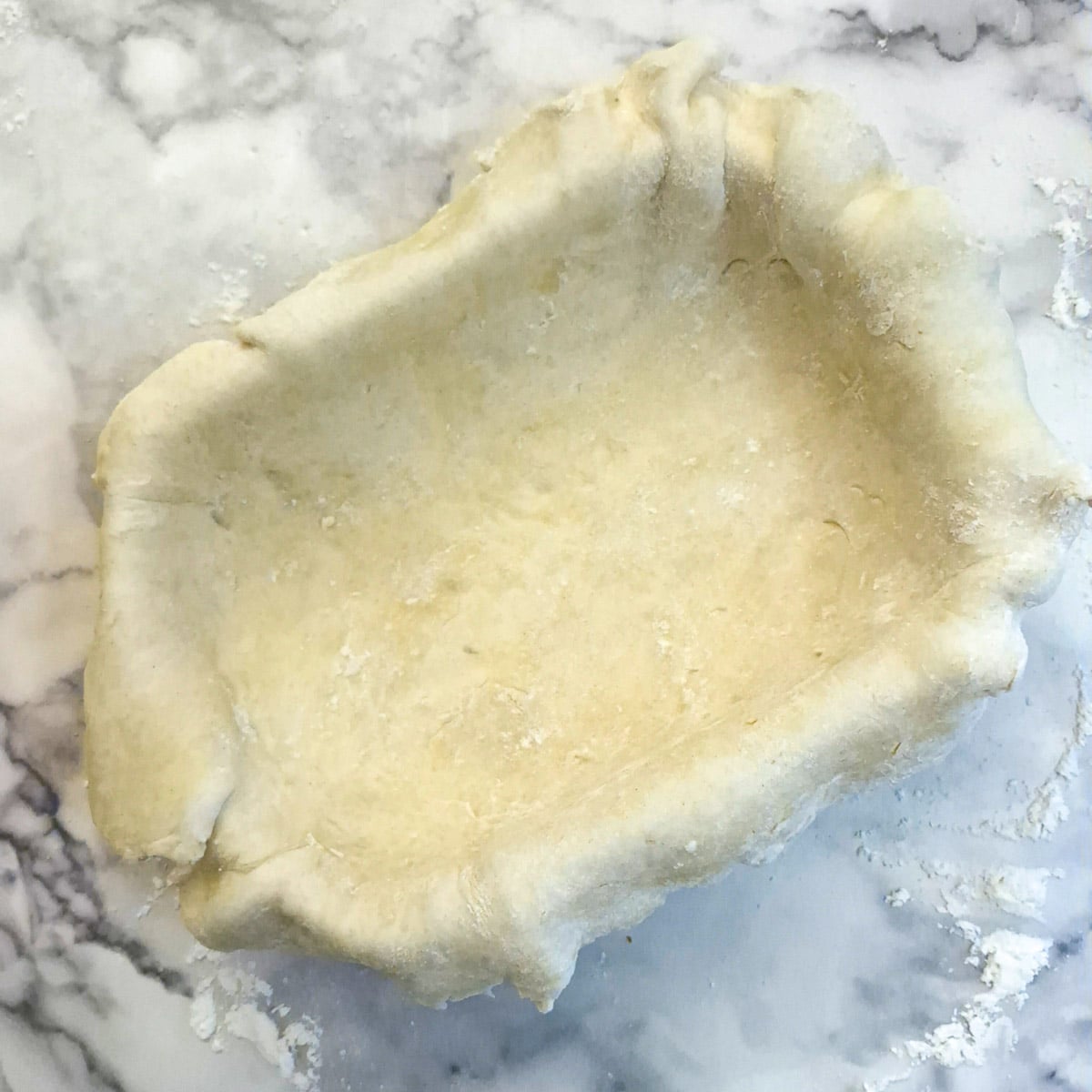 A baking dish lined with pastry.