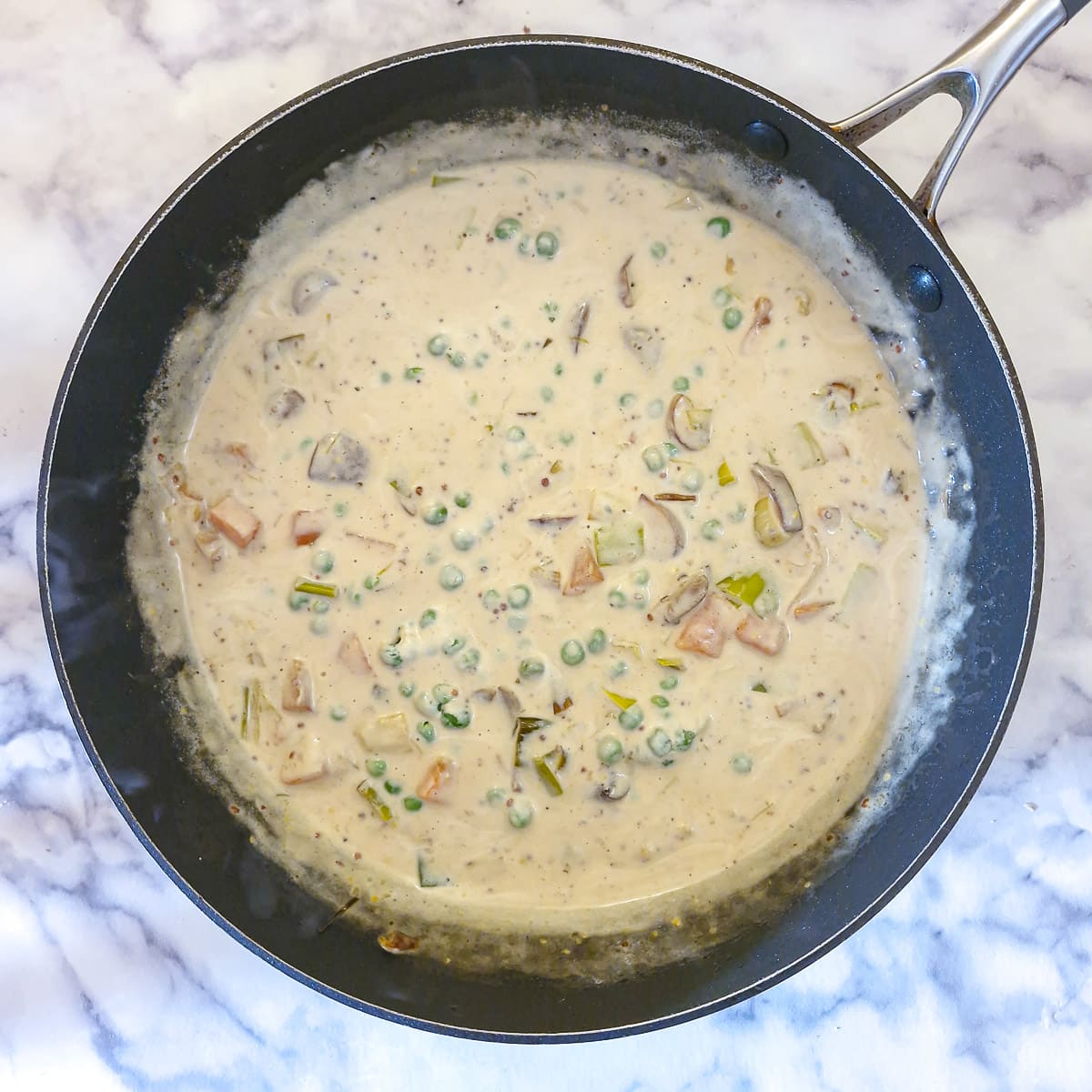 Cream and peas added to the vegetables and stock.