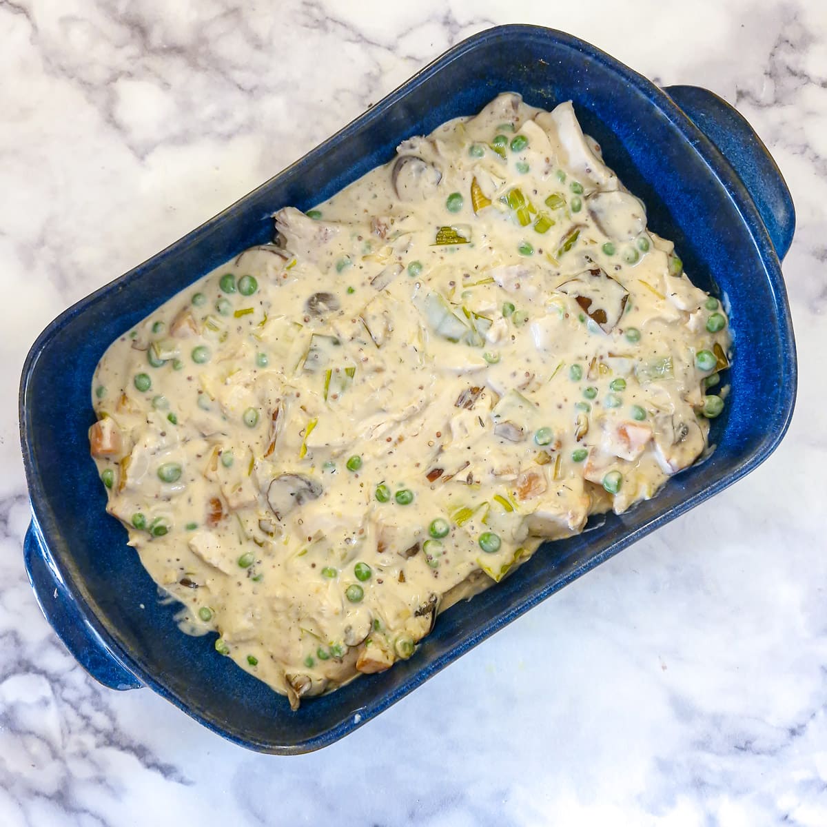 Creamy chicken sauce in a blue serving dish.