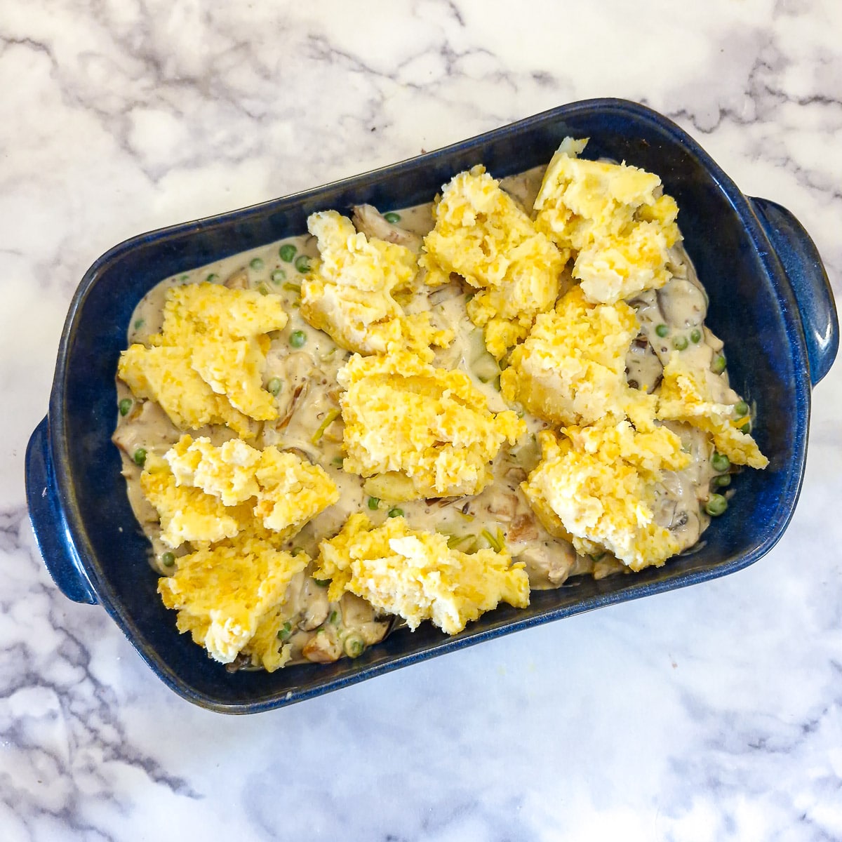 Spoonfuls of potato mash on top of the chicken filling.