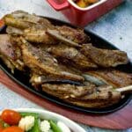Lamb ribs on a wooden serving dish.