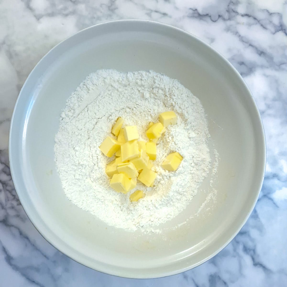 Flour and cubed butter in a large mixing bowl.