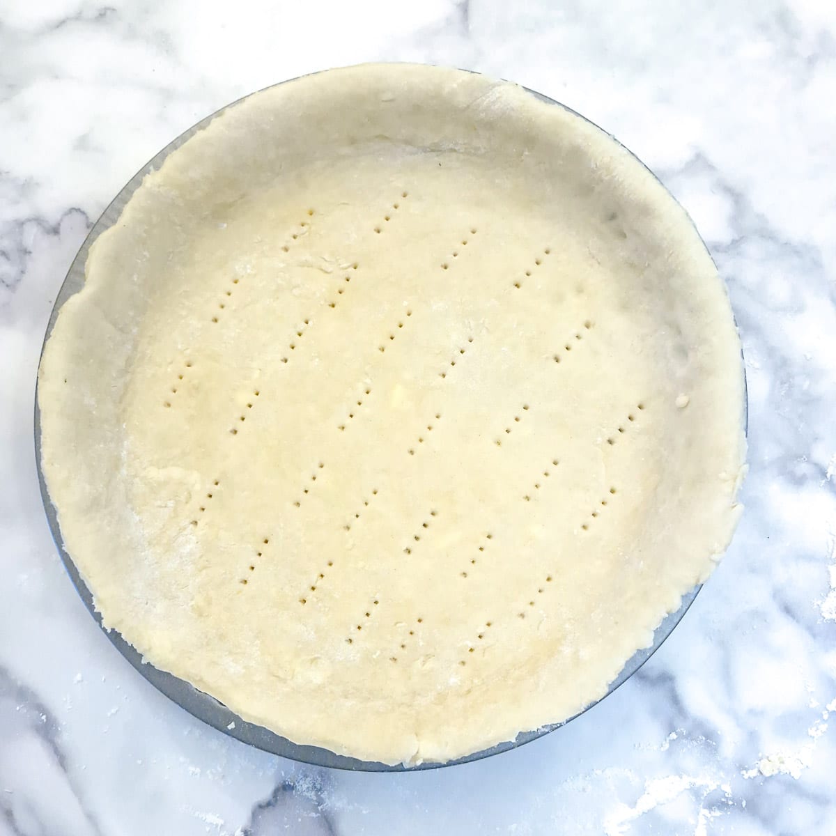 A flan dish lined with pastry.