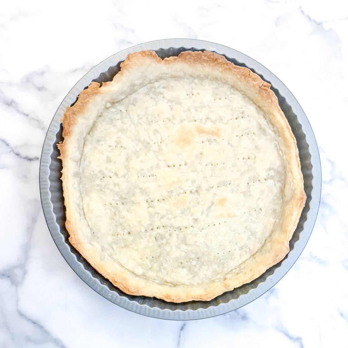 A fully baked pastry shell with nicely browned edges.