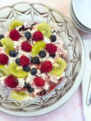 A glass serving dish filled with fruity Eton mess.