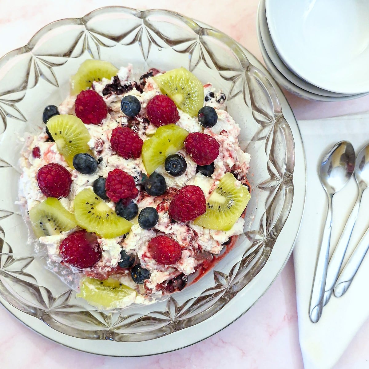 A glass serving dish filled with fruity Eton mess.