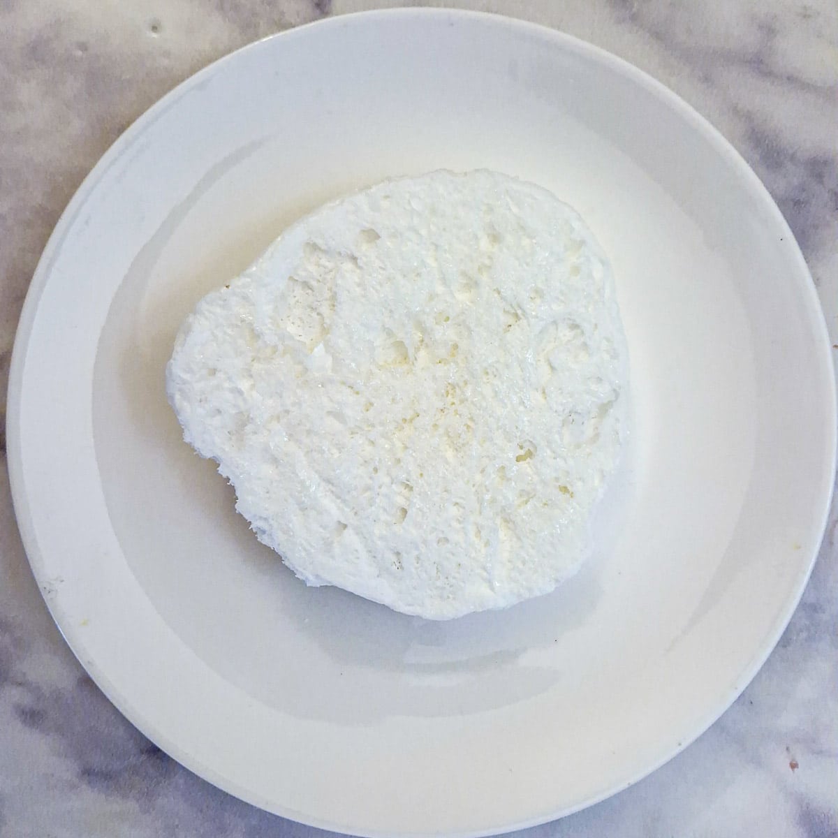 The underside of a microwave meringue showing how light and airy it is.