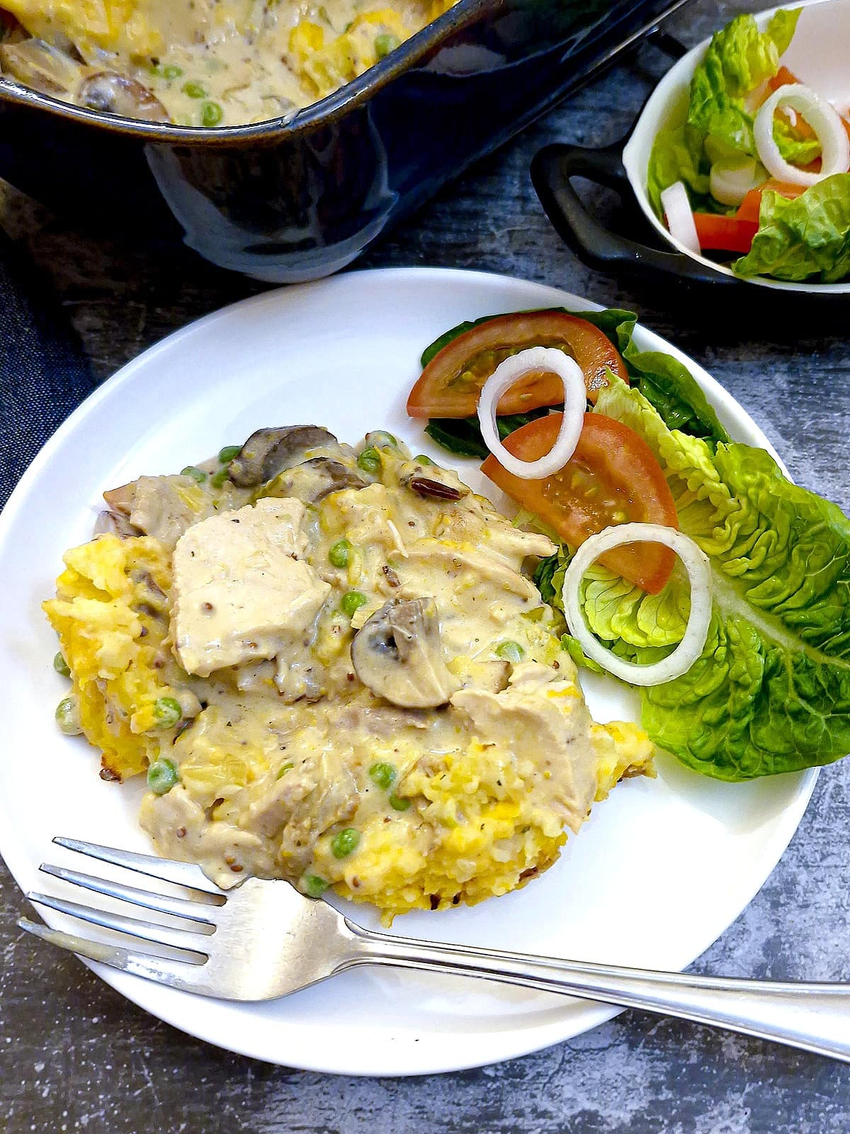 A plate of leftover chicken shepherd's pie with a side helping of green salad.