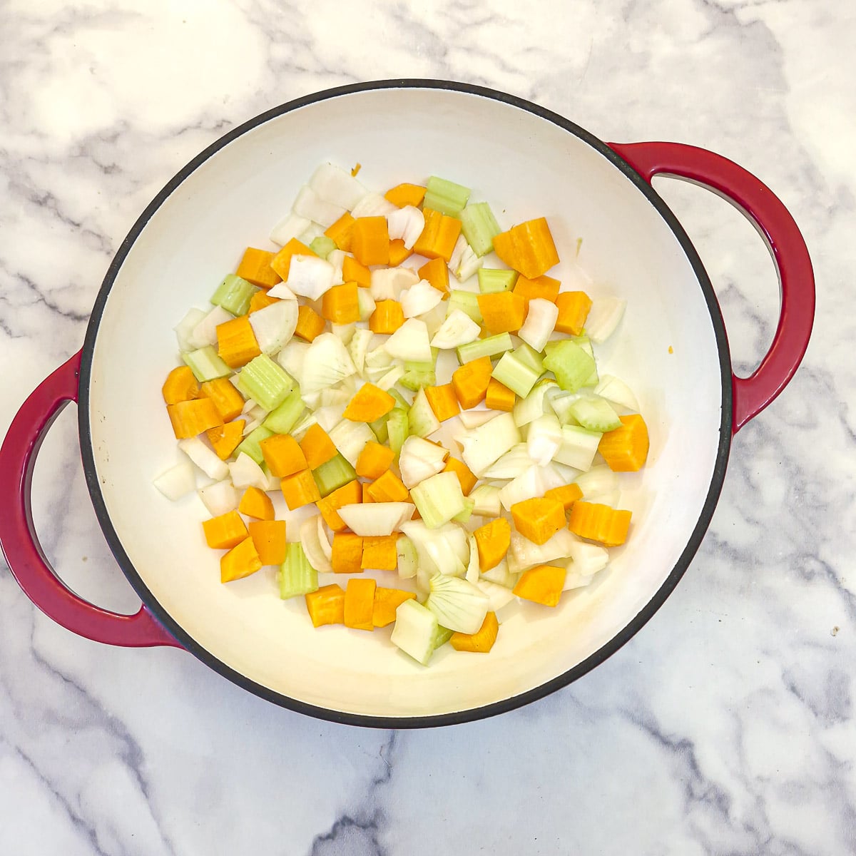 Diced onions, carrots and celery in a dutch oven.