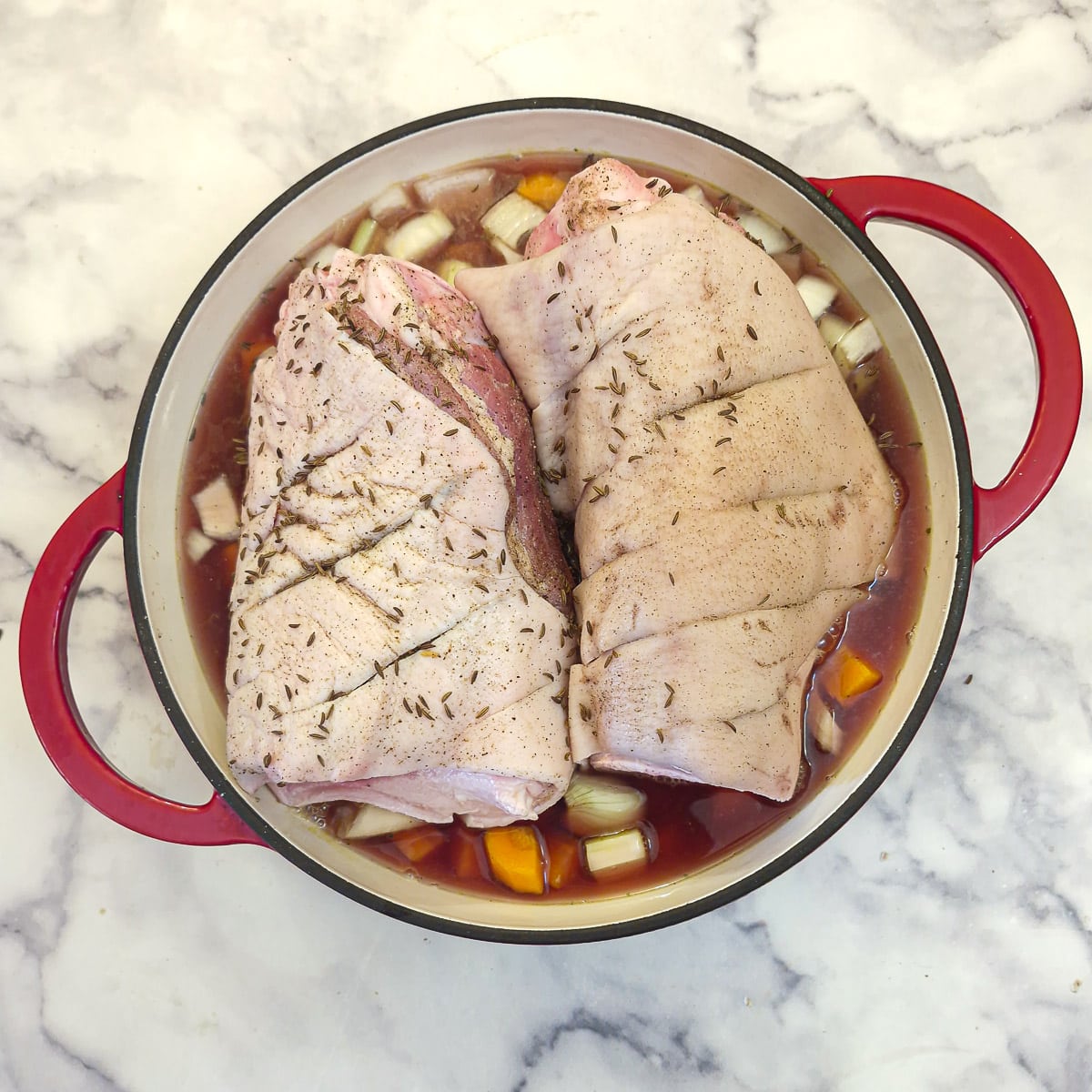 Stock added to the pork in the dutch oven.