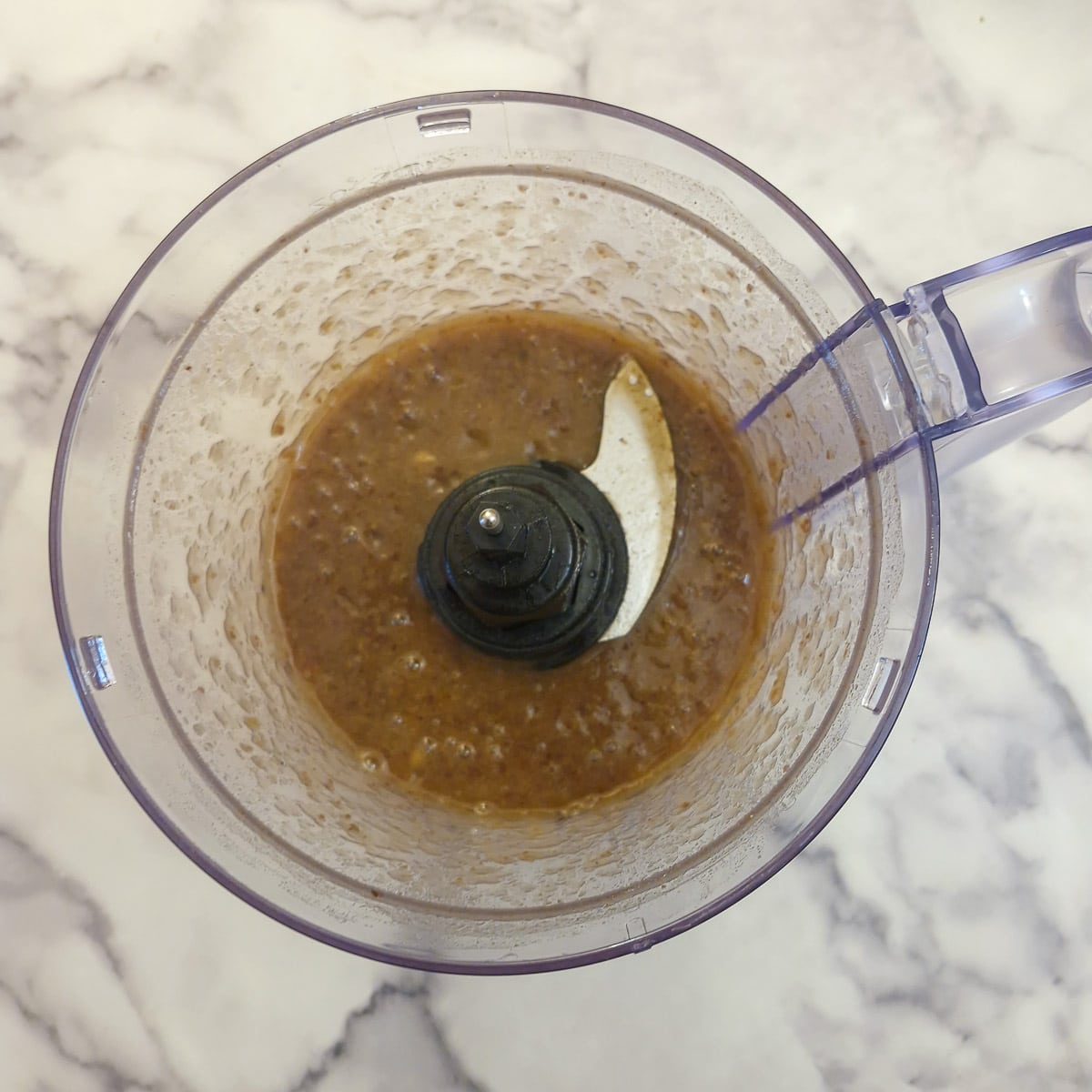 Finely blended dates and water in a food processwor.