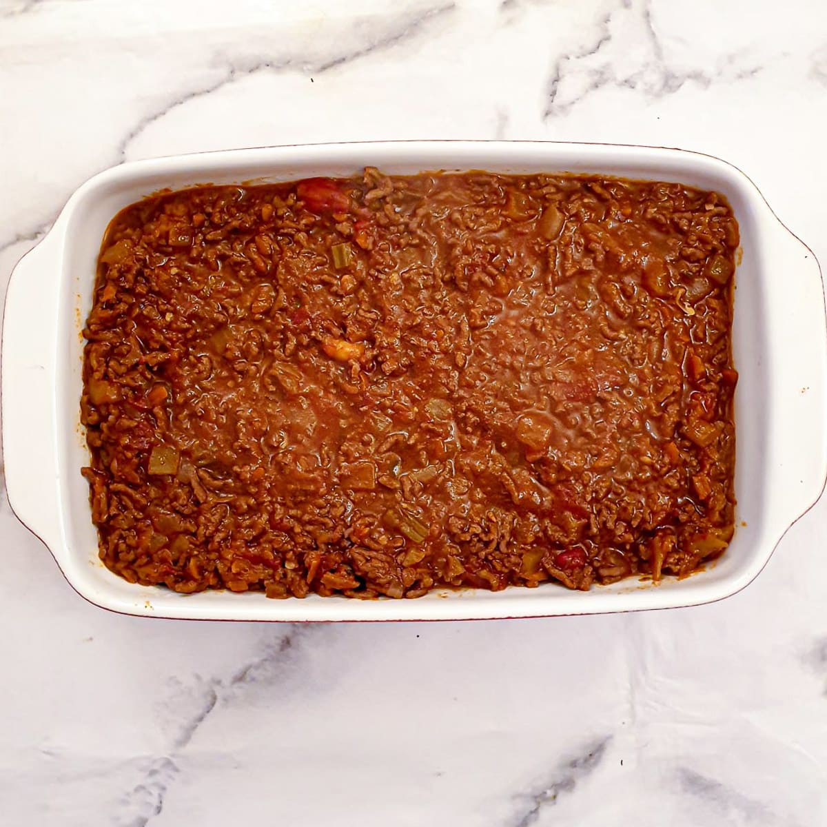 Step 10 - cover the macaroni with meat sauce.