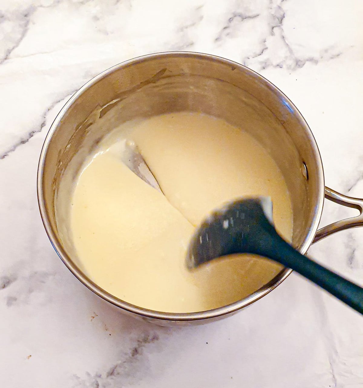 Step 6 - add the milk and allow the sauce to thicken.