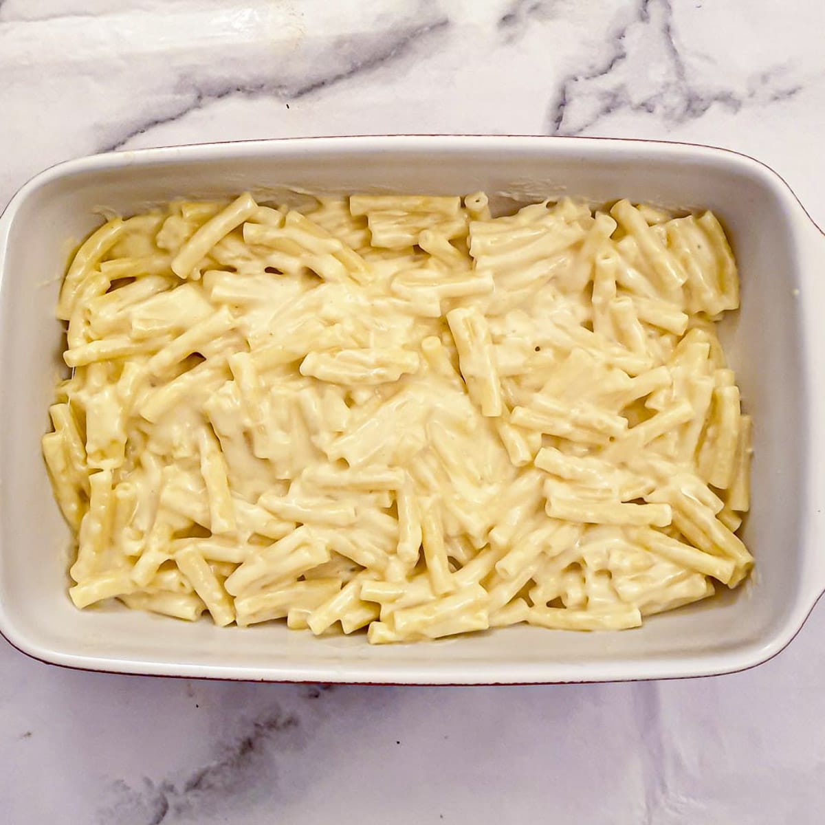 Step 9 - arrange half of the macaaroni in a baking dish.