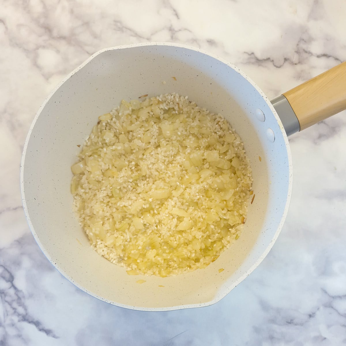 Arborio rice combined with softened onions.