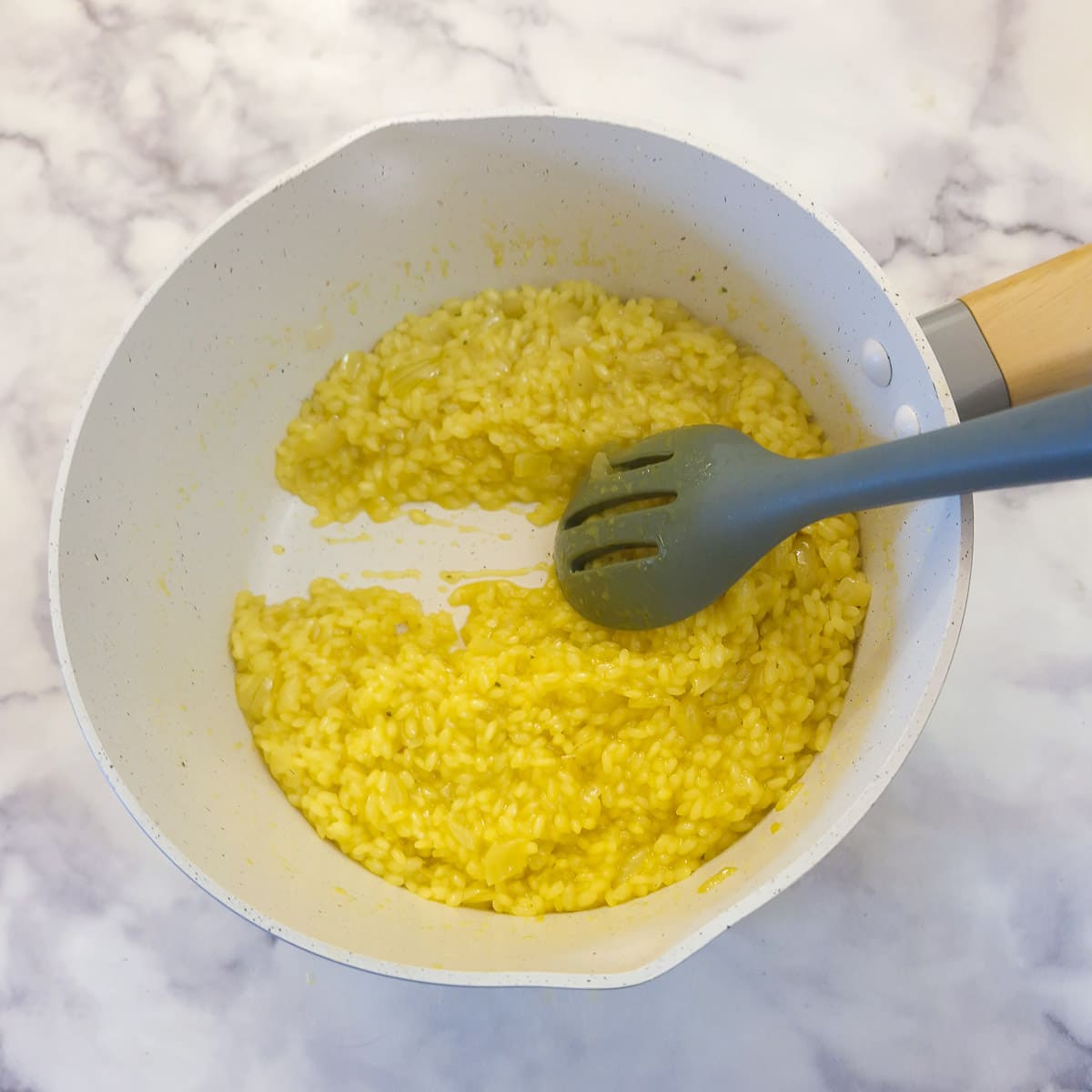 Cooked risotto in a saucepan showing the creamy consistency.